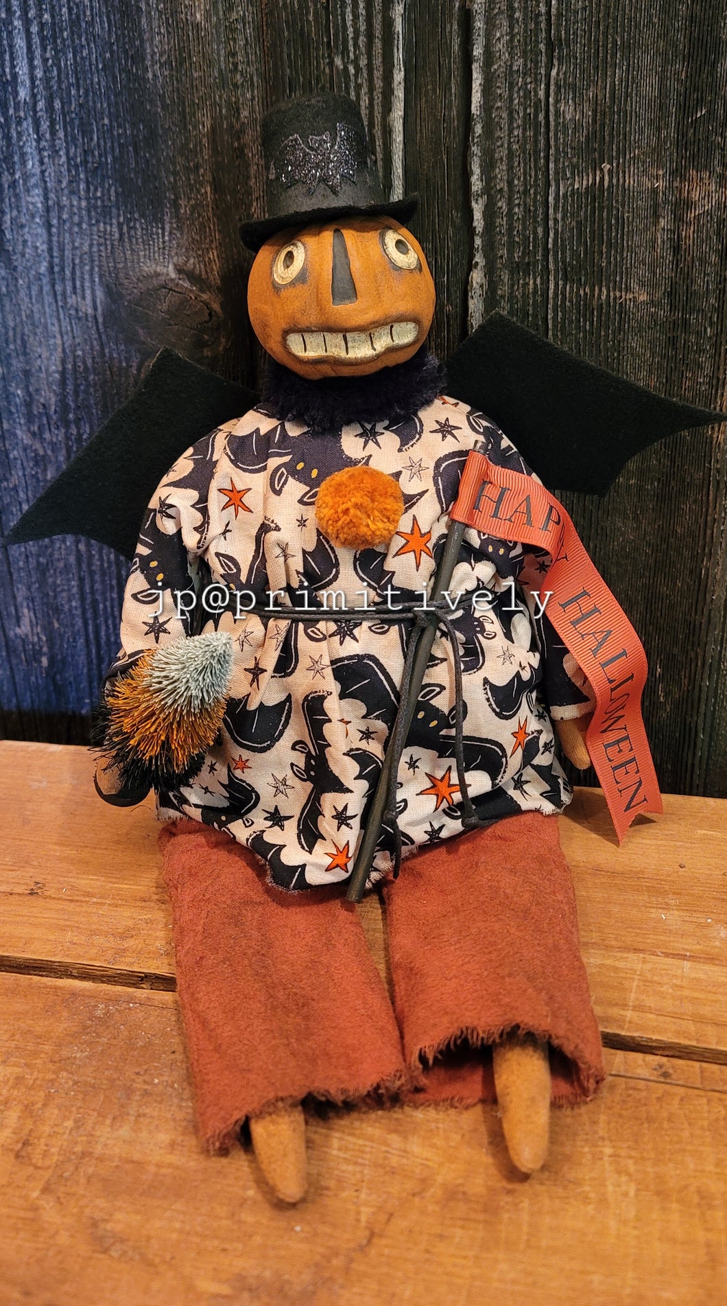 Clay head folk art sitting pumpkin boy with bat wings and tree