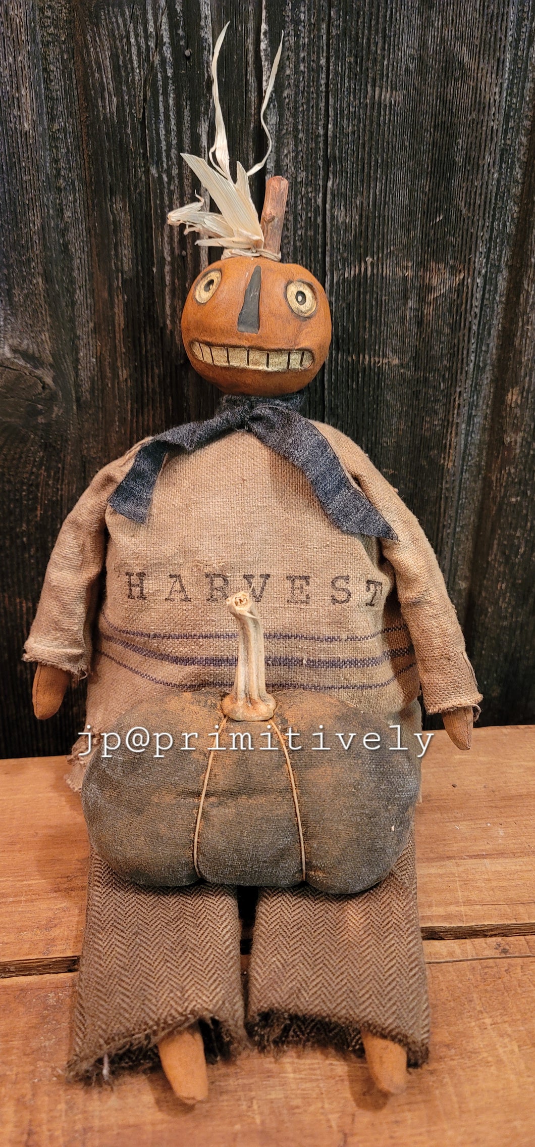 Clay head primitive sitting pumpkin with feedsack shirt and pumpkin