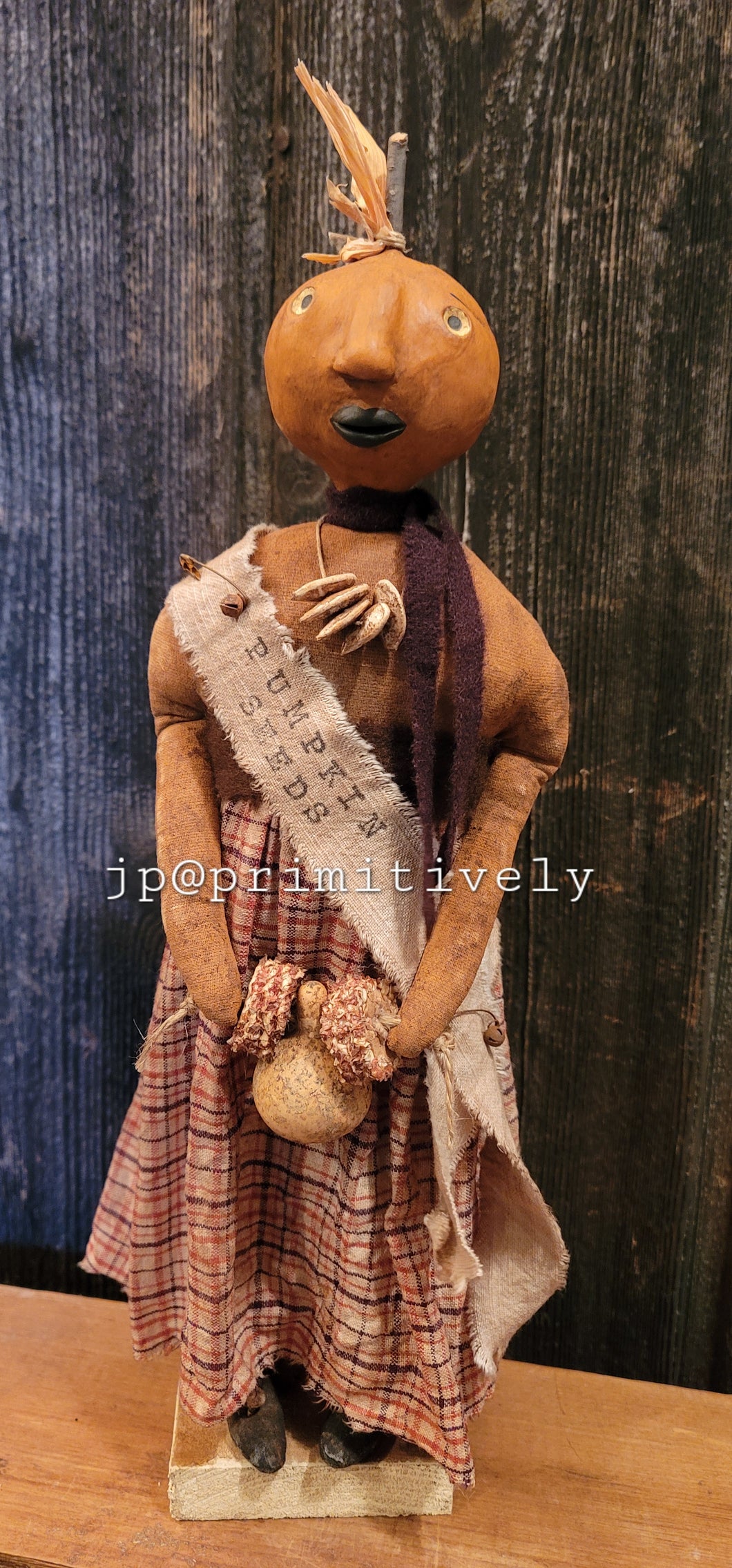 Clay head pumpkin girl with banner and gourd garland