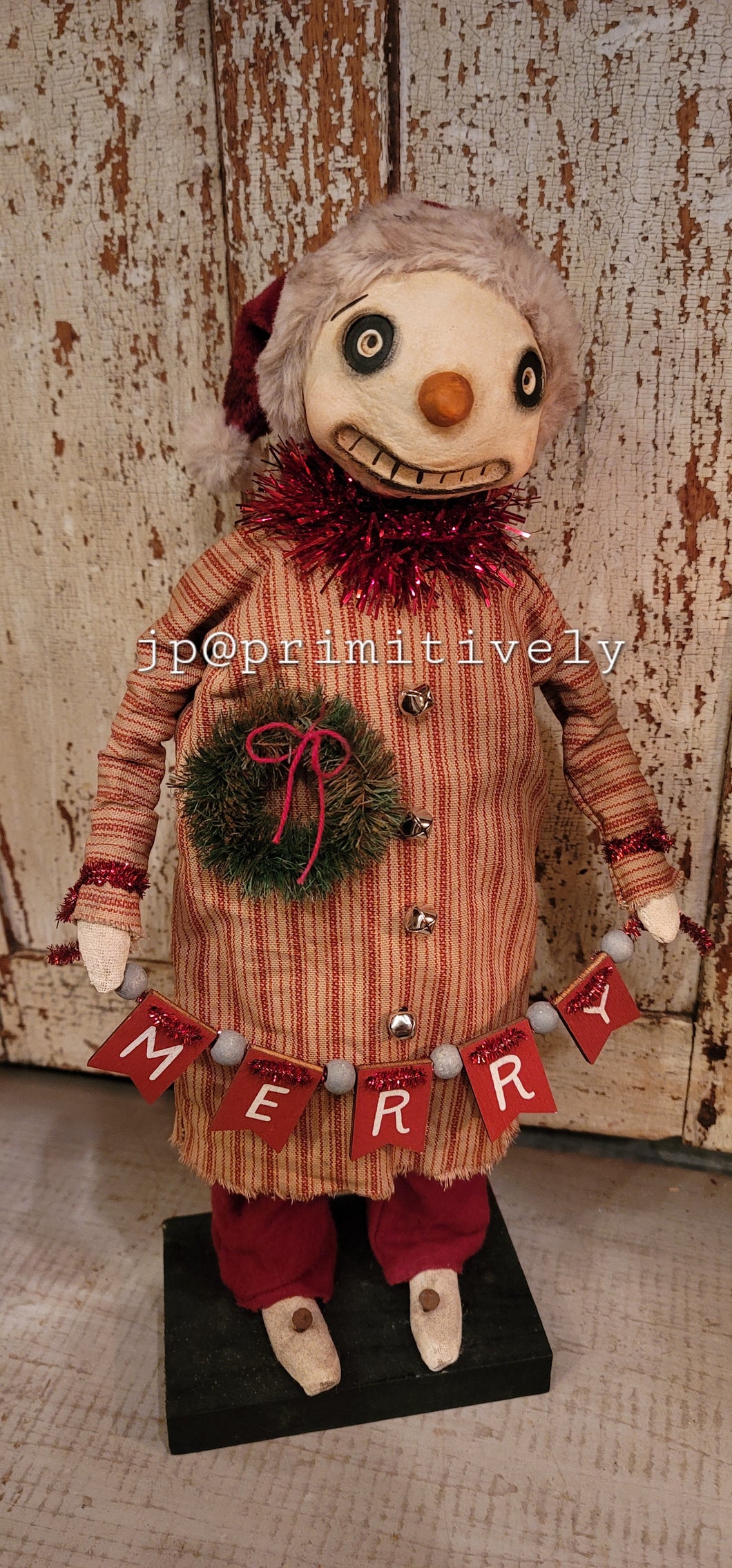 Clay head snowman holding merry banner